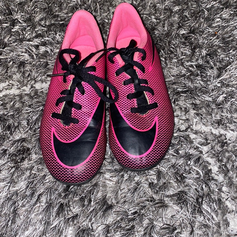 Pink and black Nike cleats